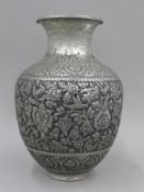 A Persian tinned on copper vase with repousse decorations. 33 cm high.