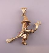 A 9 ct gold articulated witch on a broomstick form pendant. Approximately 4 cm high. 7.