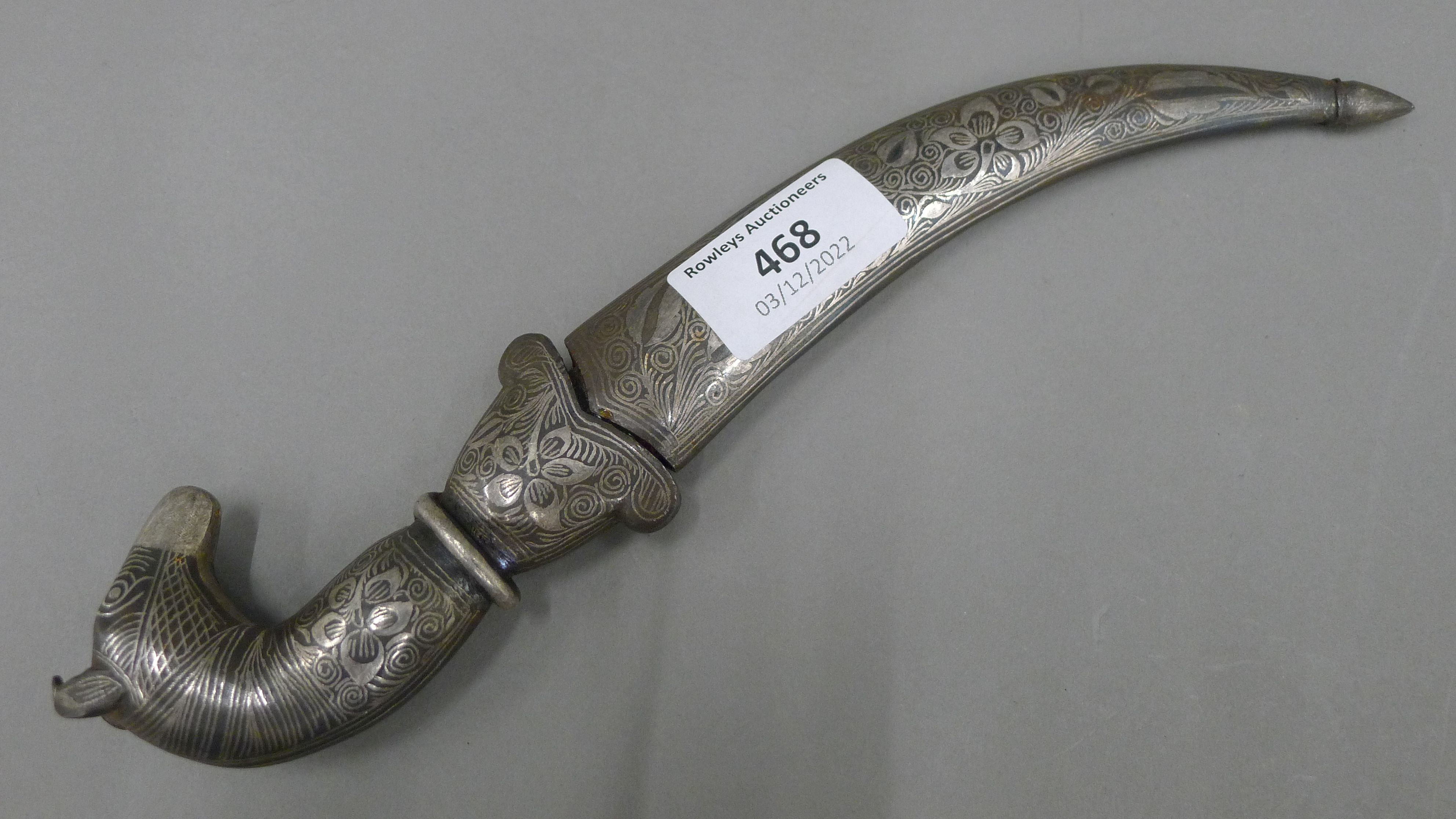 A 19th century Persian knife, the steel scabbard and grip inlaid with silver,