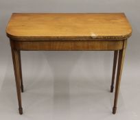 A 19th century mahogany fold over card table. 91 cm wide.