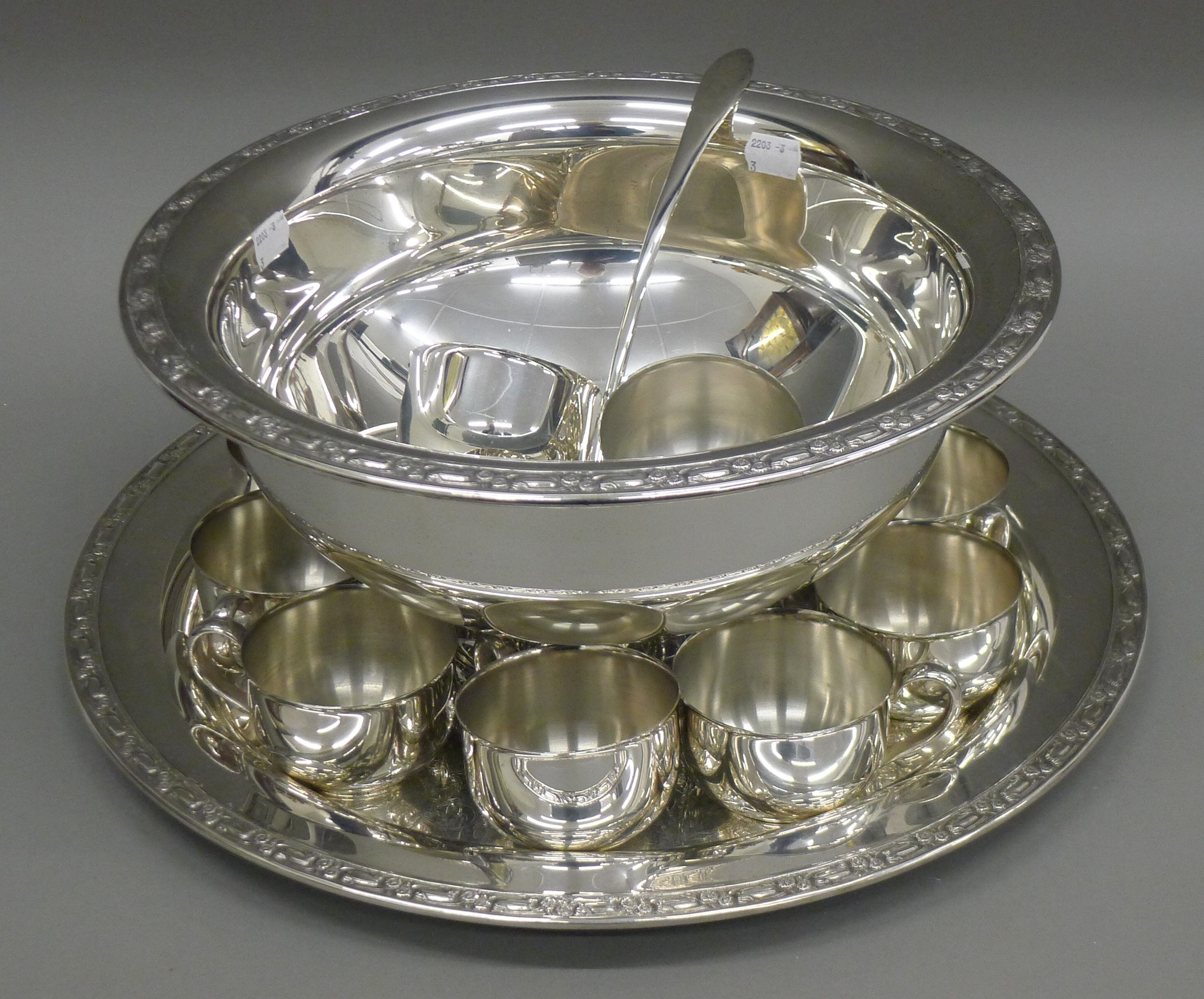 A silver plated punch set.
