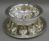 A silver plated punch set.
