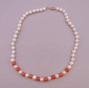 A 14 ct gold coral and pearl necklace. Approximately 40 cm long.