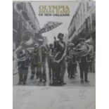 A signed Olympia brass band of New Orleans poster, glazed. 43 x 55.5 cm.