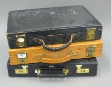 Three vintage briefcases.
