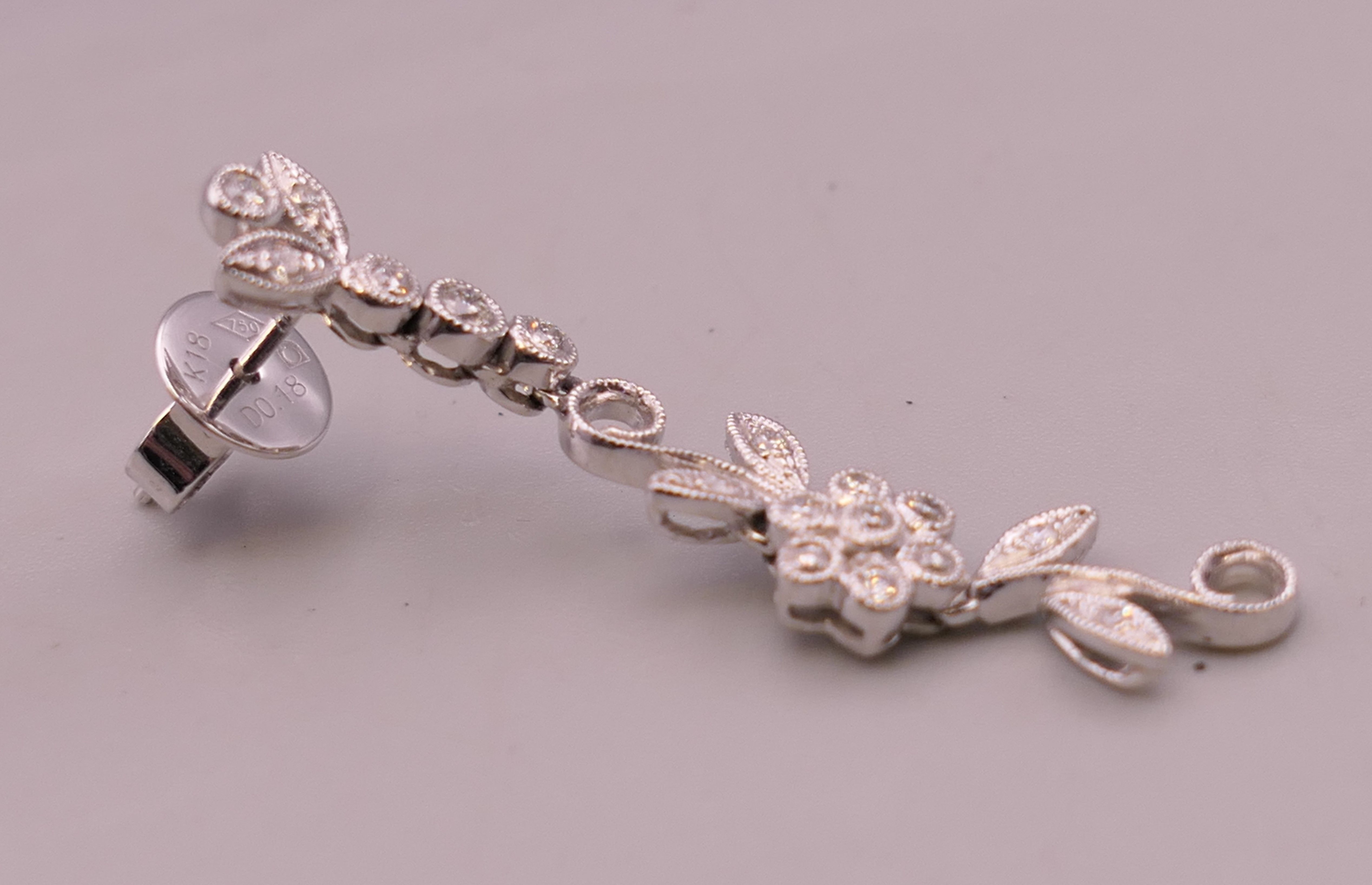A pair of 18 ct white gold diamond flower drop earrings. Approximately 4 cm long. - Image 8 of 12