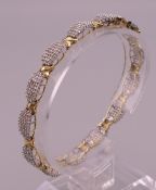 A 10 K gold and diamond bracelet. 18 cm long. 13.9 grammes total weight.