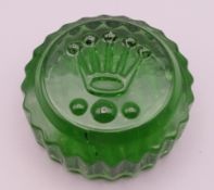 A Rolex green glass paperweight. 7 cm diameter.