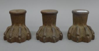 Three carved hairy paw feet.