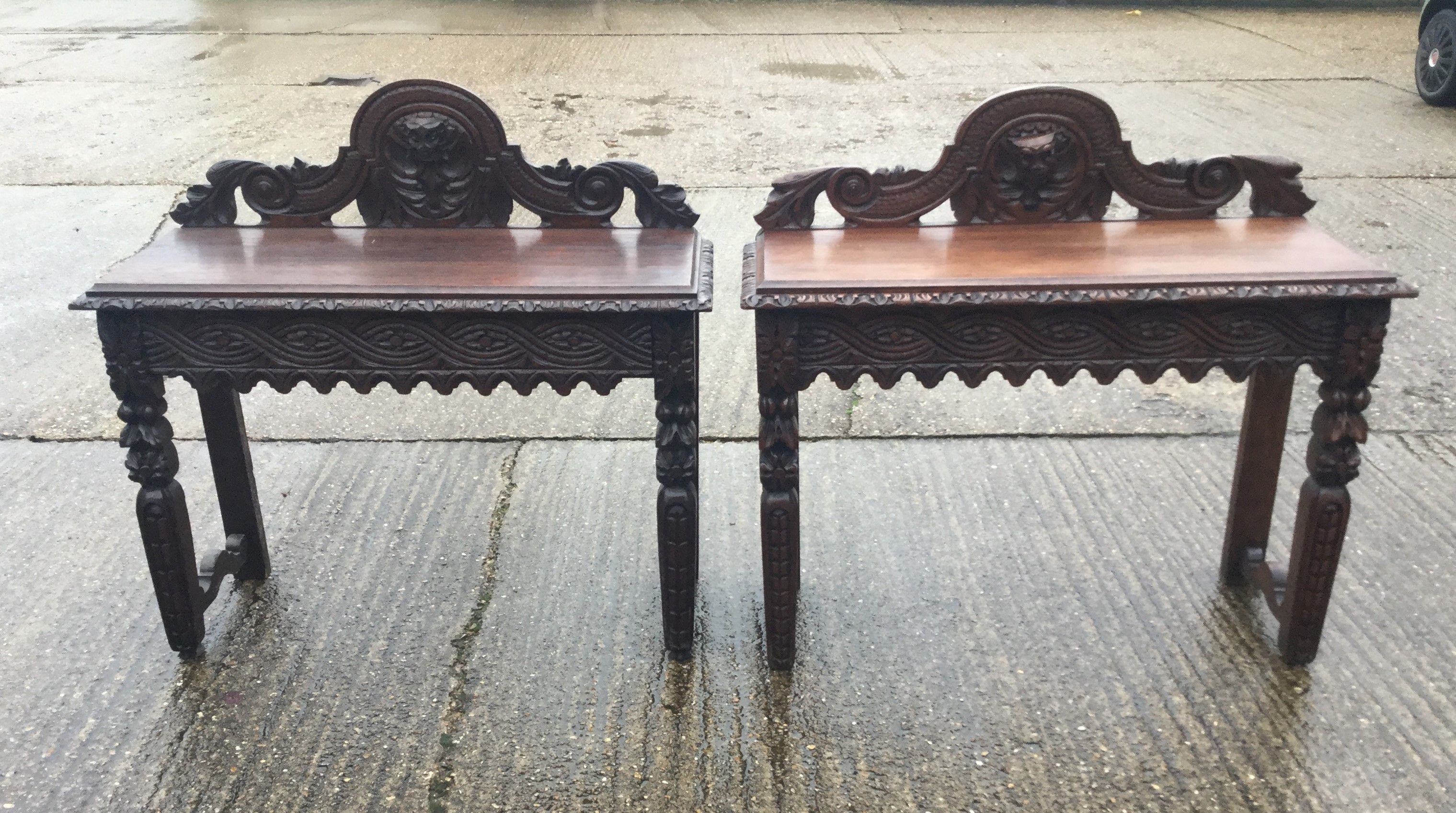 Two carved oak side tables. The largest 106 cm wide.