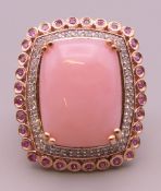 A silver, pink stone and cubic zirconia ring. Ring size Q/R.