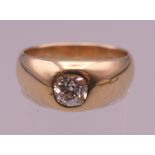 An unmarked gold diamond gypsy set ring. Ring size P/Q. 7.3 grammes total weight.