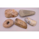 Four various Stone Age axe heads and a Stone Age hammer head. The largest 15 cm long.