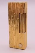 A Dunhill lighter. 6.5 cm high.