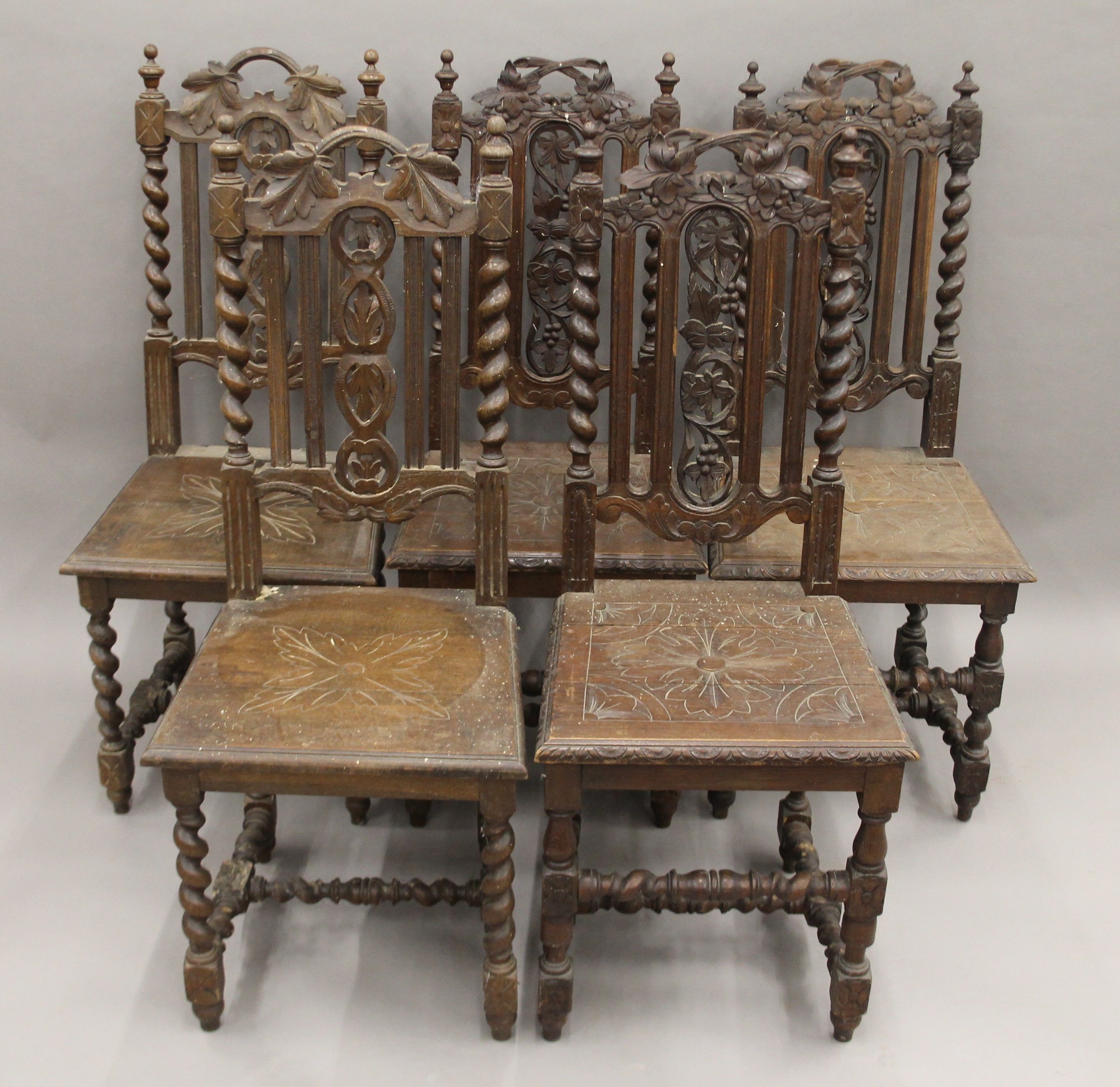 Five various carved oak barley twist chairs.