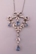 An Art Nouveau platinum, diamond and aquamarine pendant on chain. The pendant 4.25 cm high. 5.