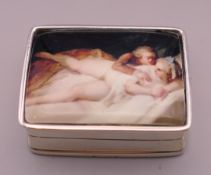 A silver pill box depicting lovers. 3 cm x 2.5 cm.