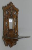 A Victorian carved mirrored wall bracket. 36 cm high.