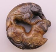 An archaic style jade roundel. Approximately 5 cm diameter.