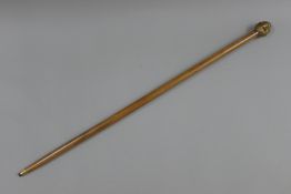 A walking stick with four-faced Buddha handle. 92 cm long.