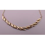 A 9 ct gold necklace set with diamonds. Approximately 42 cm long. 5.9 grammes total weight.