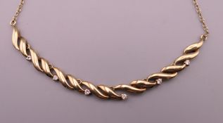 A 9 ct gold necklace set with diamonds. Approximately 42 cm long. 5.9 grammes total weight.