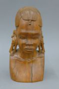 An African hardwood carving of a tribal woman, signed J Mulli. 24 cm high.