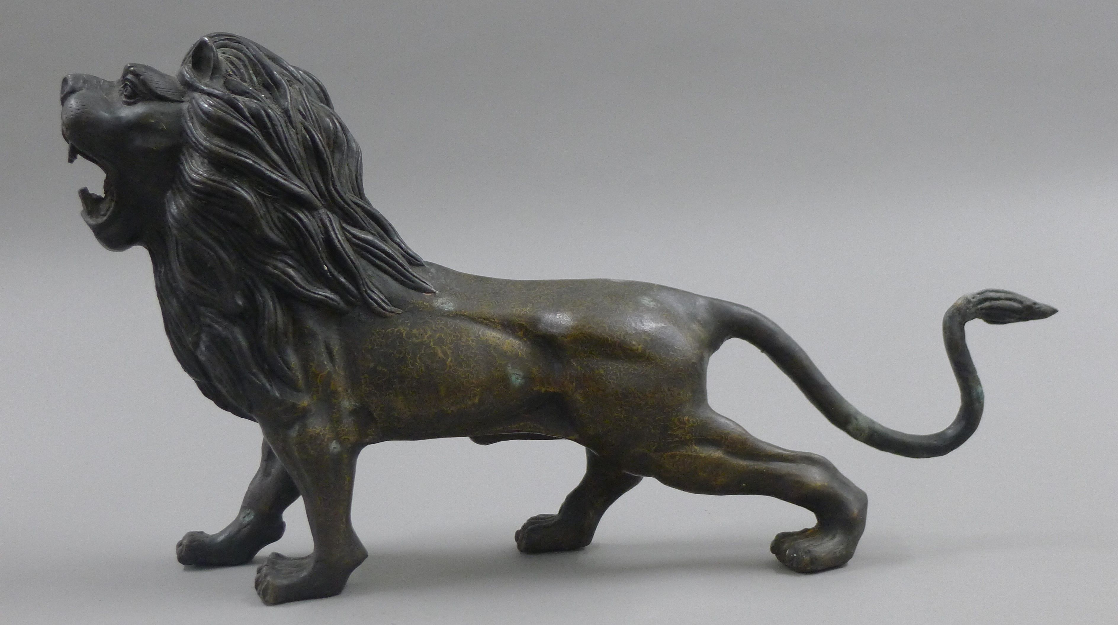 A bronze model of a lion. 56 cm long.
