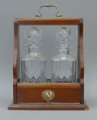 A mahogany two bottle tantalus. 24.5 cm wide.