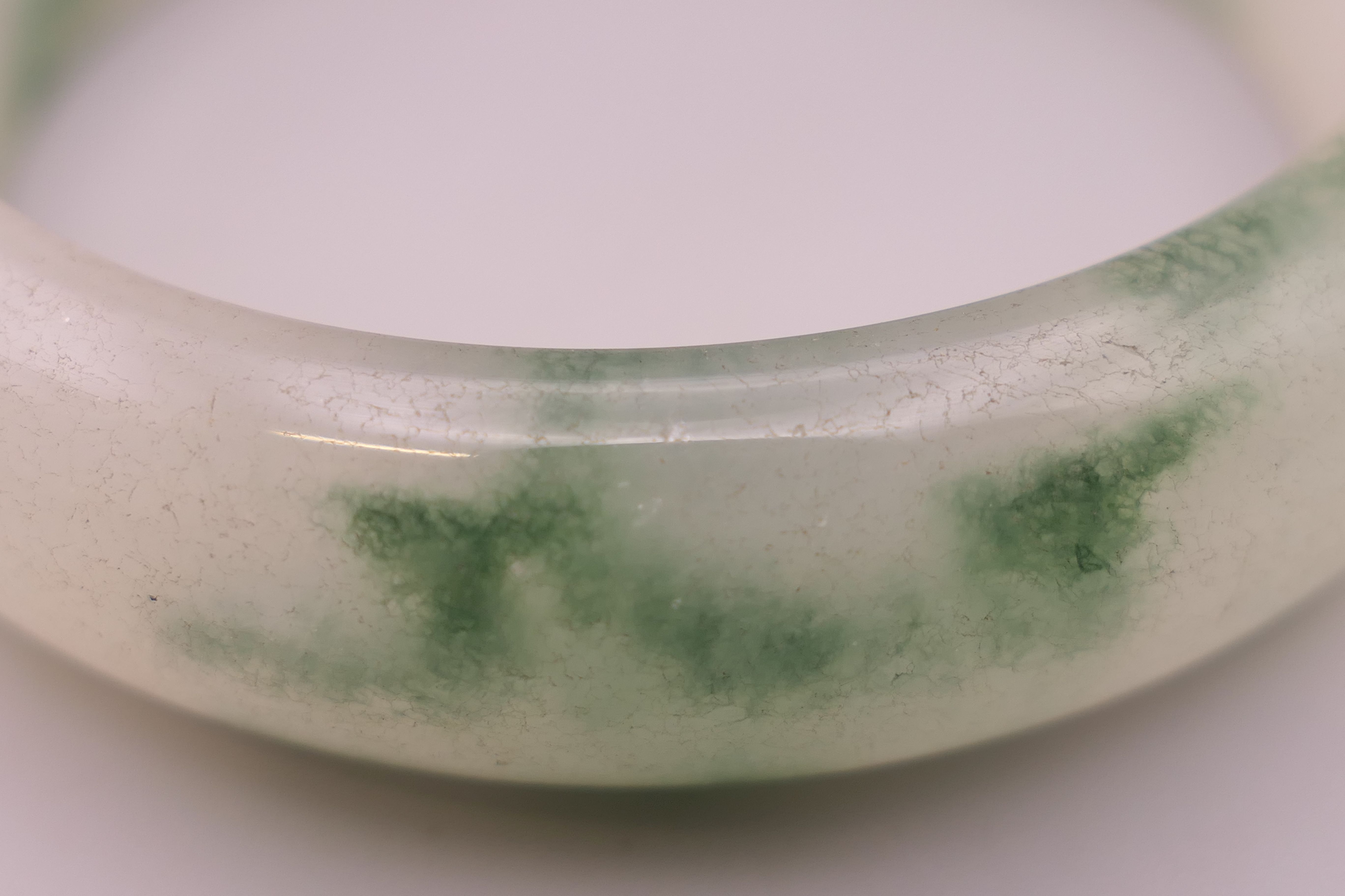 A jade bangle. Internal diameter 5.75 cm. - Image 2 of 3