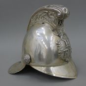 A vintage silver plated fireman's helmet.