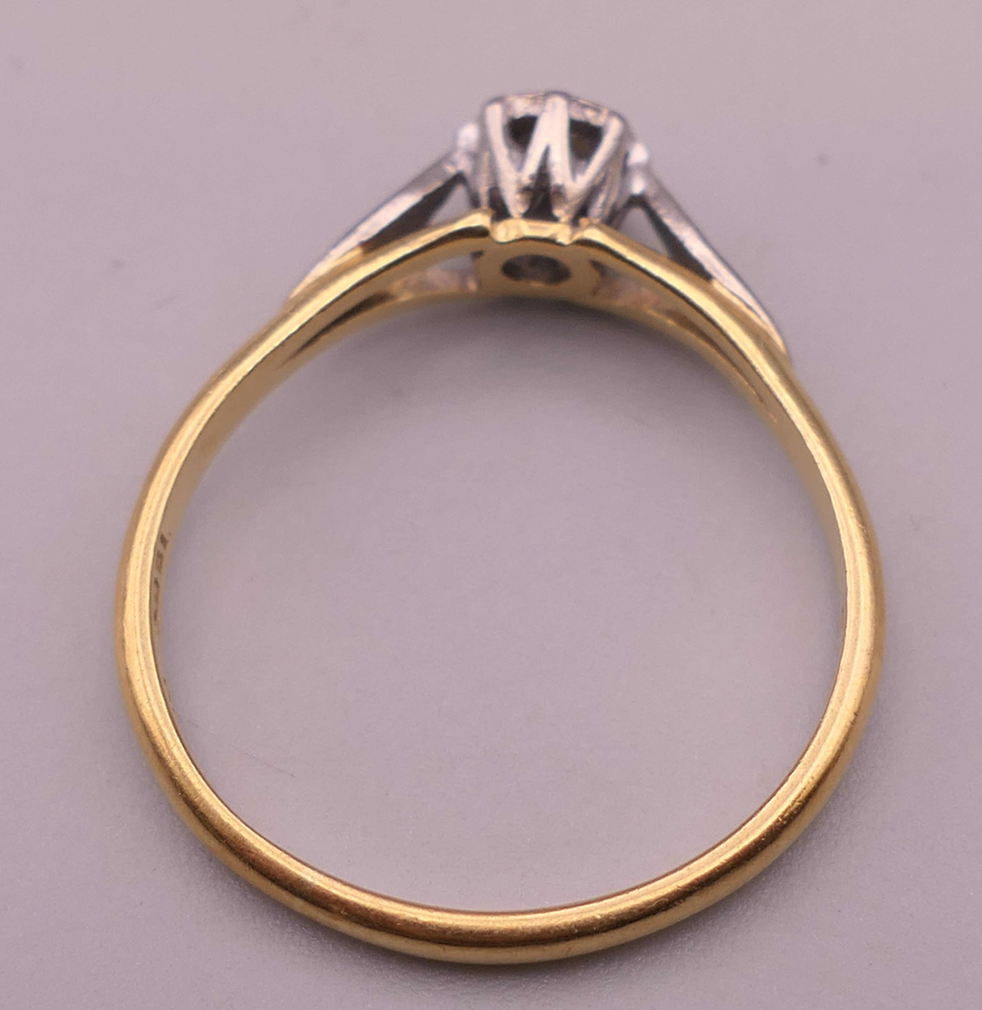 An 18 ct gold and platinum diamond solitaire ring. Ring size Q/R. 2.8 grammes total weight. - Image 2 of 5