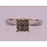 A 9 ct white gold diamond ring. Ring size K/L. 1.9 grammes total weight.