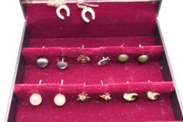 A collection of silver earrings.