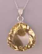 A 9 ct white gold and citrine pendant on a silver chain. Pendant 3 cm high, chain 45 cm long.