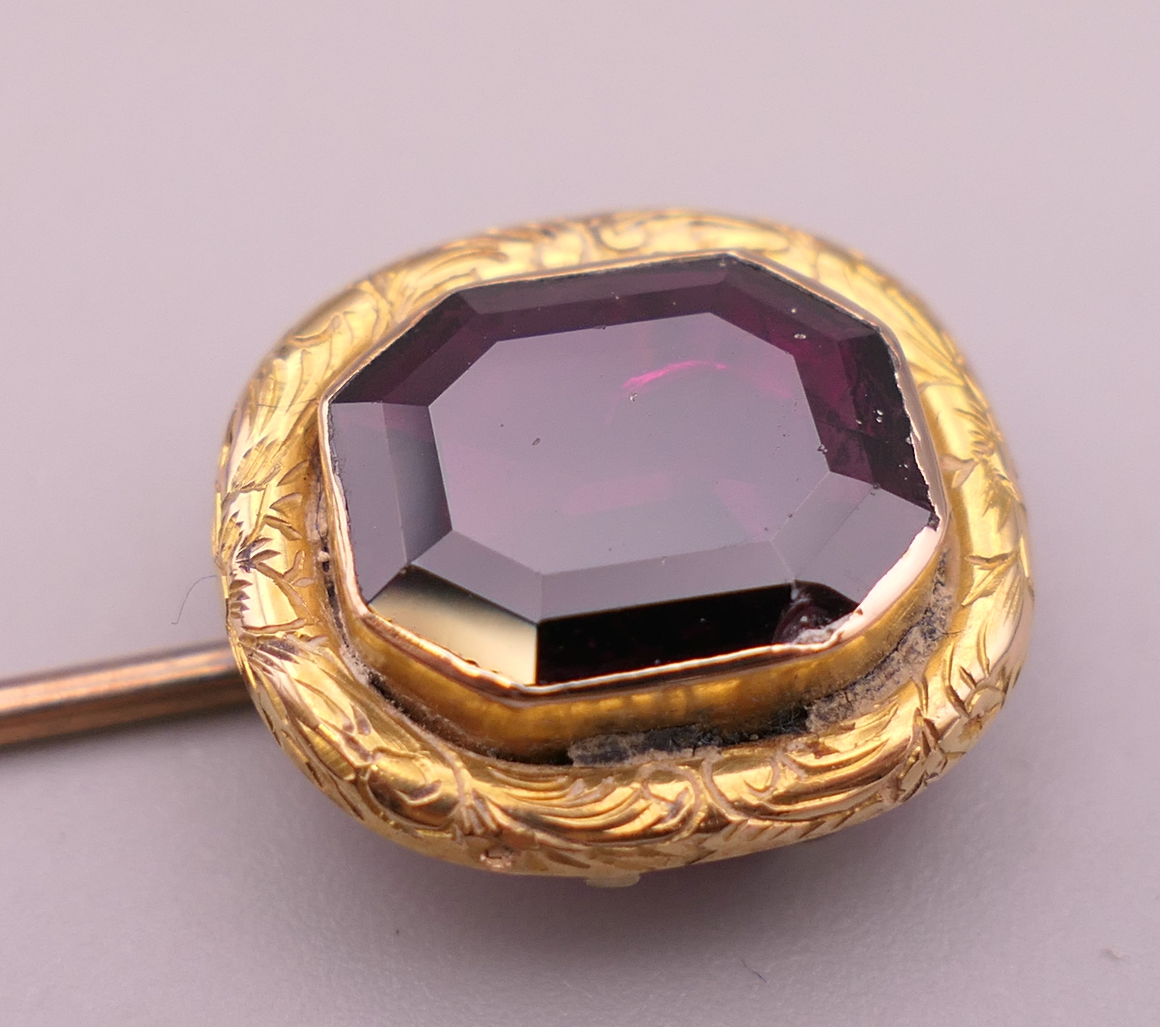 An antique unmarked gold purple stone stickpin, possibly garnet, boxed. 8 cm high. 3. - Image 2 of 6