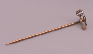 A gold aquamarine and seed pearl stickpin. 5 cm long. 0.9 grammes total weight.