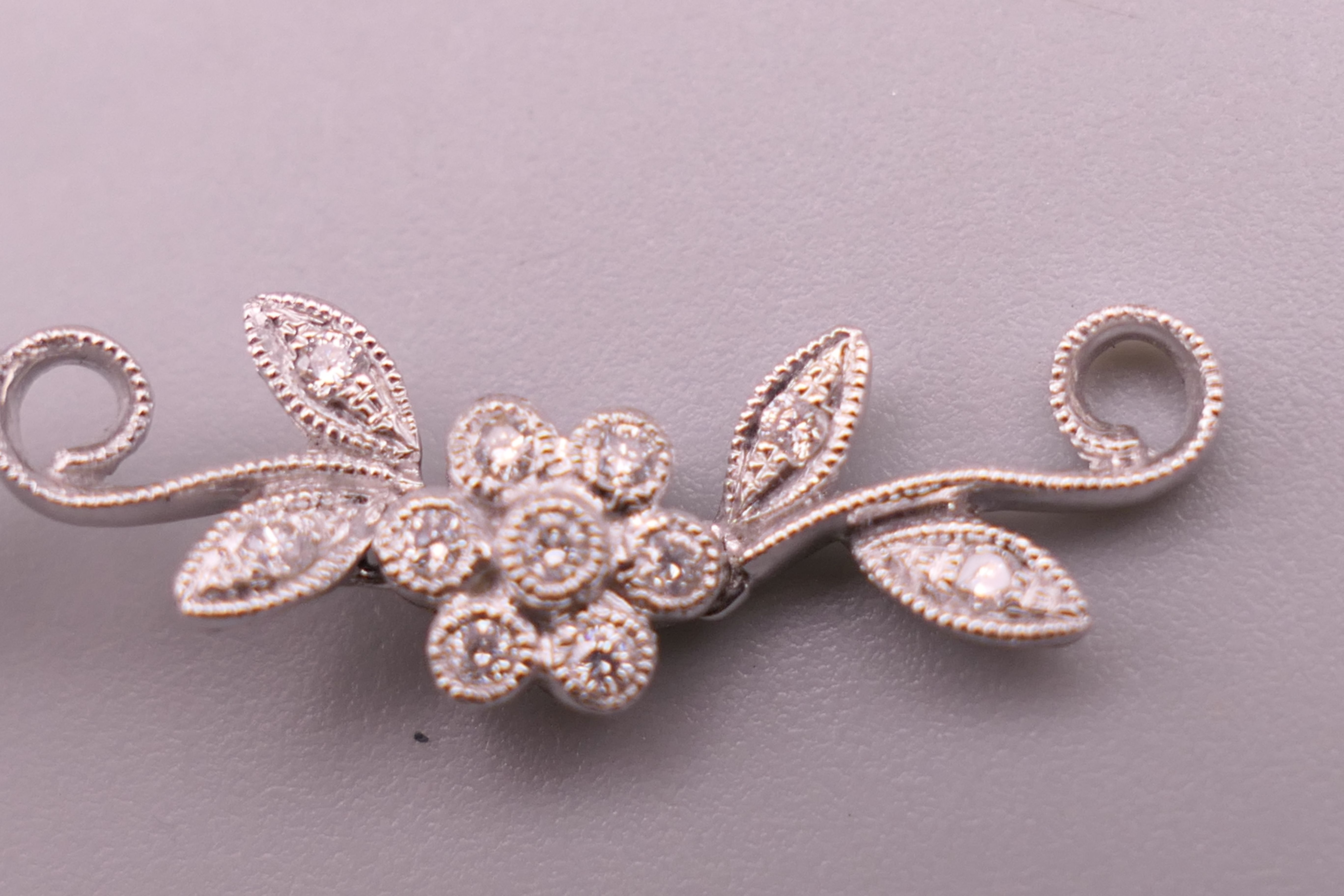 A pair of 18 ct white gold diamond flower drop earrings. Approximately 4 cm long. - Image 9 of 12