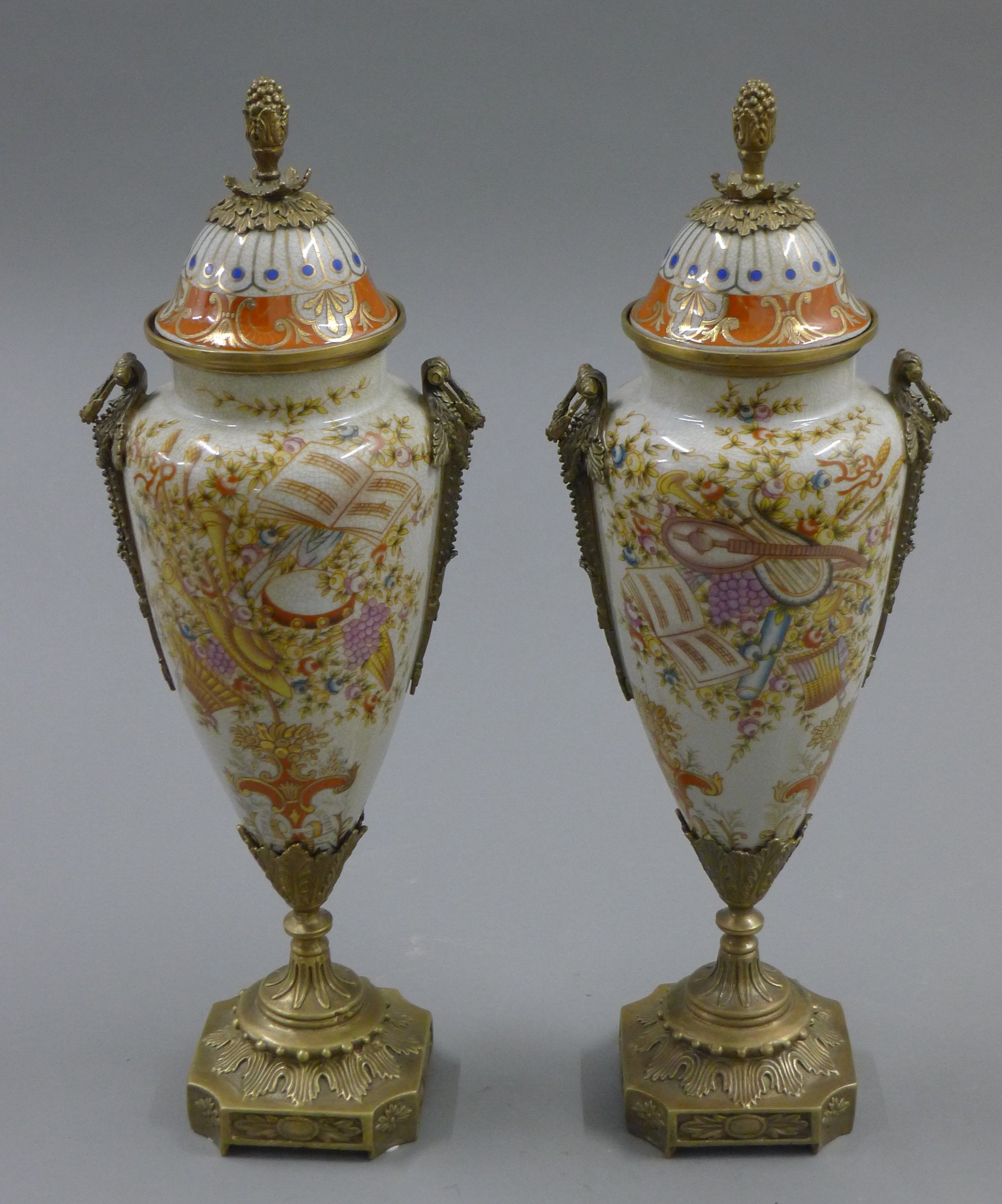 A pair of metal mounted porcelain lidded vases. 37 cm high.