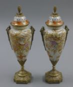 A pair of metal mounted porcelain lidded vases. 37 cm high.