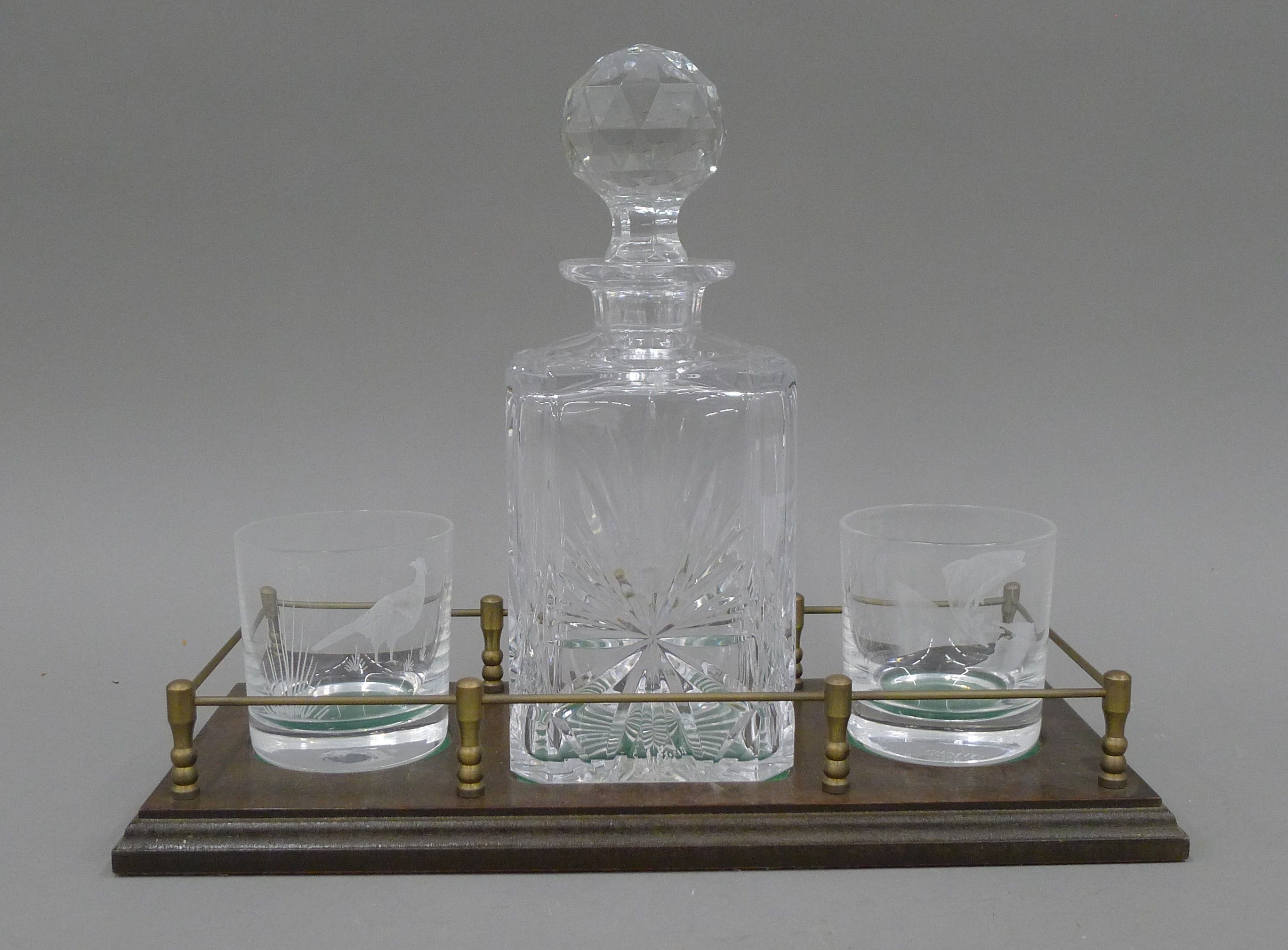 A decanter and glass stand. 35.5 cm long.