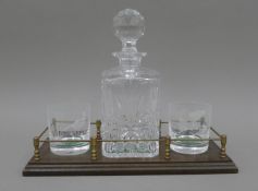 A decanter and glass stand. 35.5 cm long.