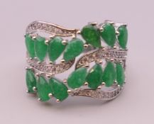 A silver, green stone and cubic zirconia ring. Ring size R/S.