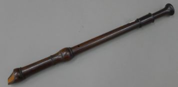 A rosewood recorder by Schott's of England. 61.5 cm long.