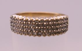 A 9 ct gold diamond set ring. Ring size N. 2.7 grammes total weight.