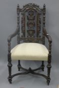 A Victorian carved oak open armchair. 63 cm wide.