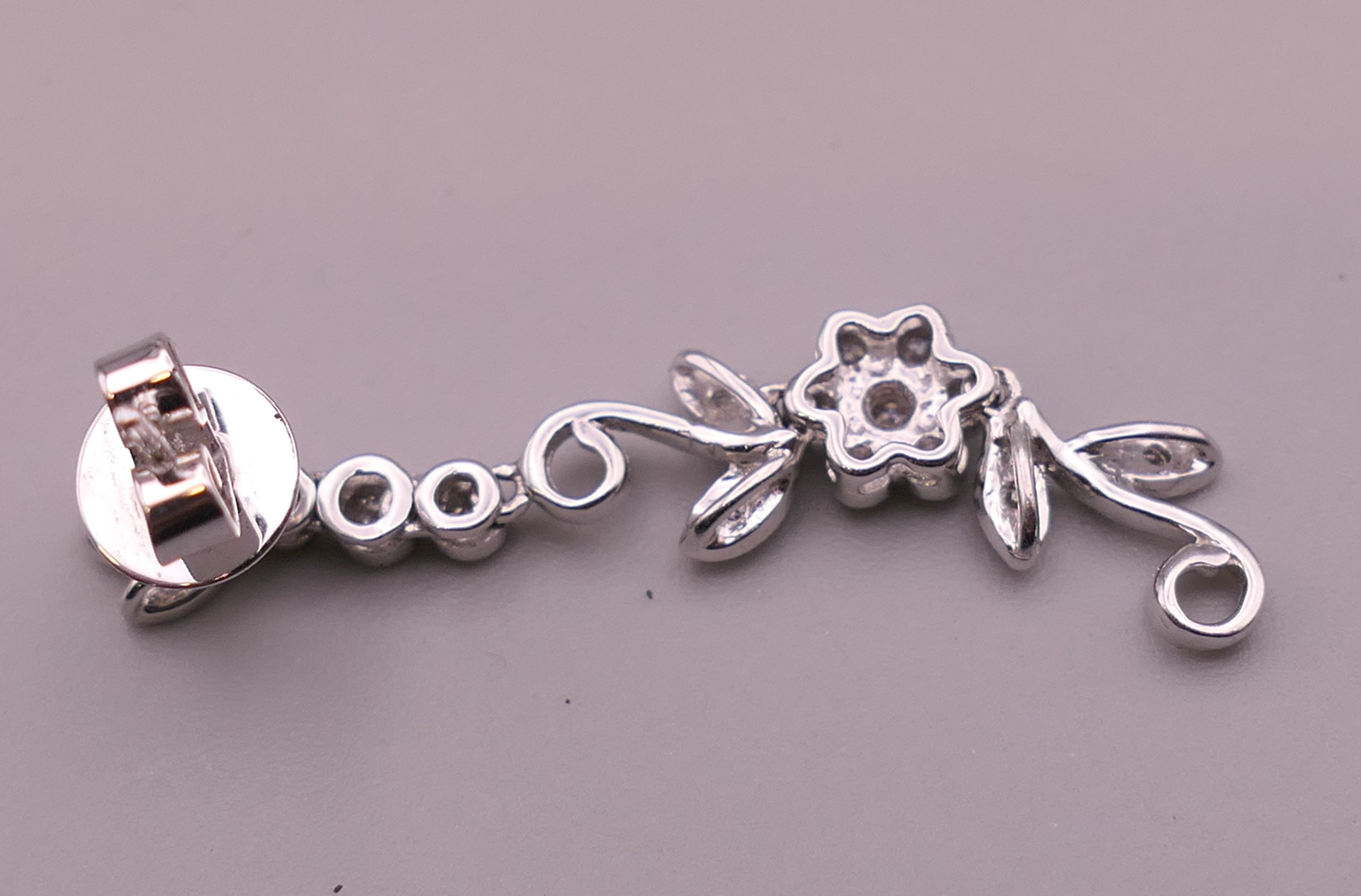 A pair of 18 ct white gold diamond flower drop earrings. Approximately 4 cm long. - Image 11 of 12