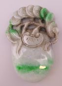 A Chinese jade fruit and money pendant. 8.5 cm high.
