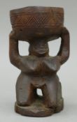 An African Kuba Tribe carved wooden cup supported by a female figure. 15.5 cm high.