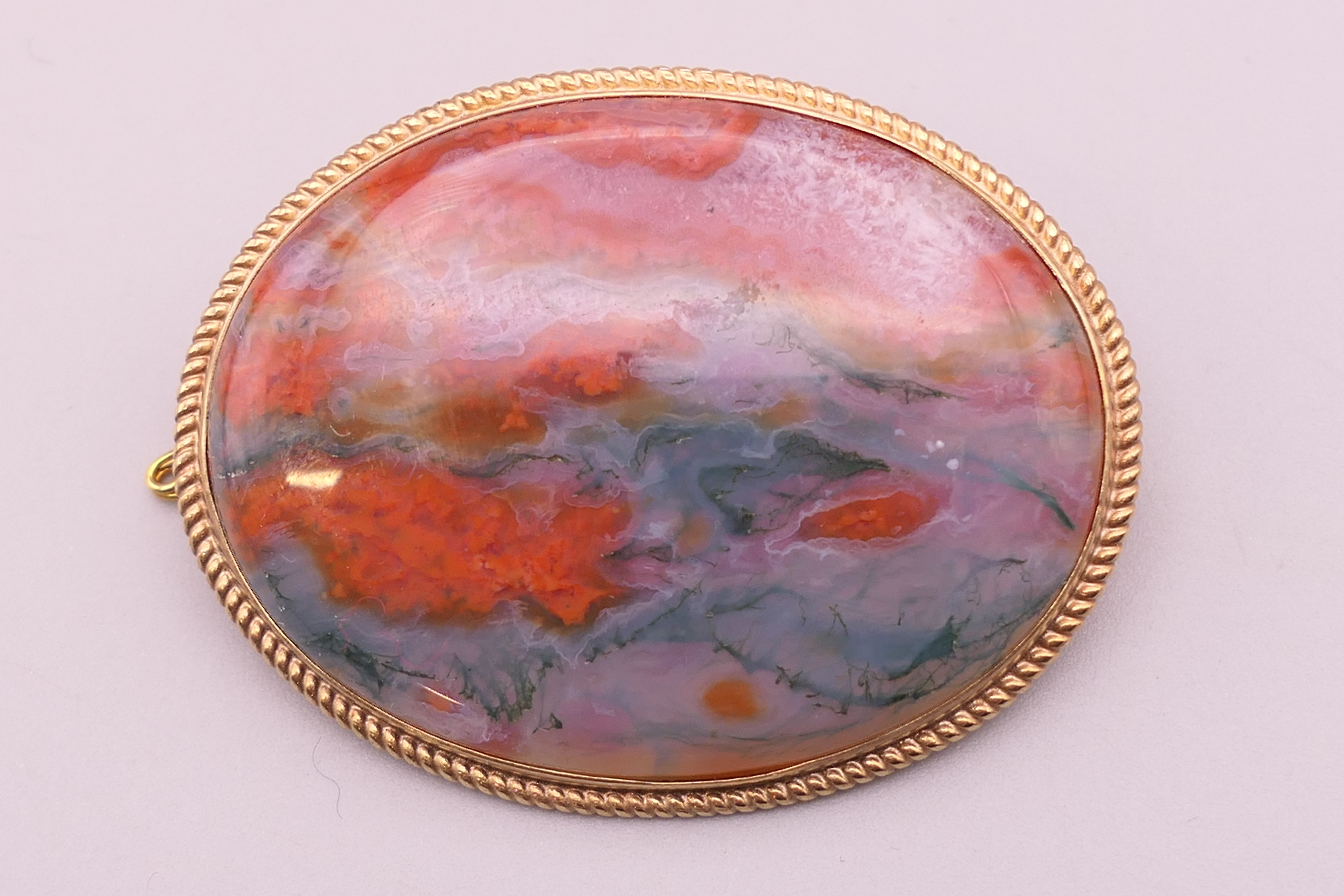 A 9 ct gold and moss agate brooch. 4.5 cm wide.